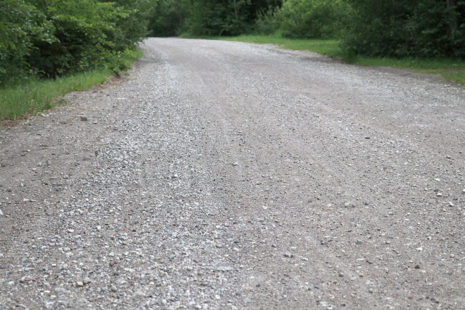 Quality gravel roads are built using rock, dirt particles (fines) and Anionic Polyacrylamide (APAM)
